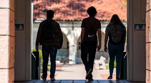 3 students walking through hepner hall